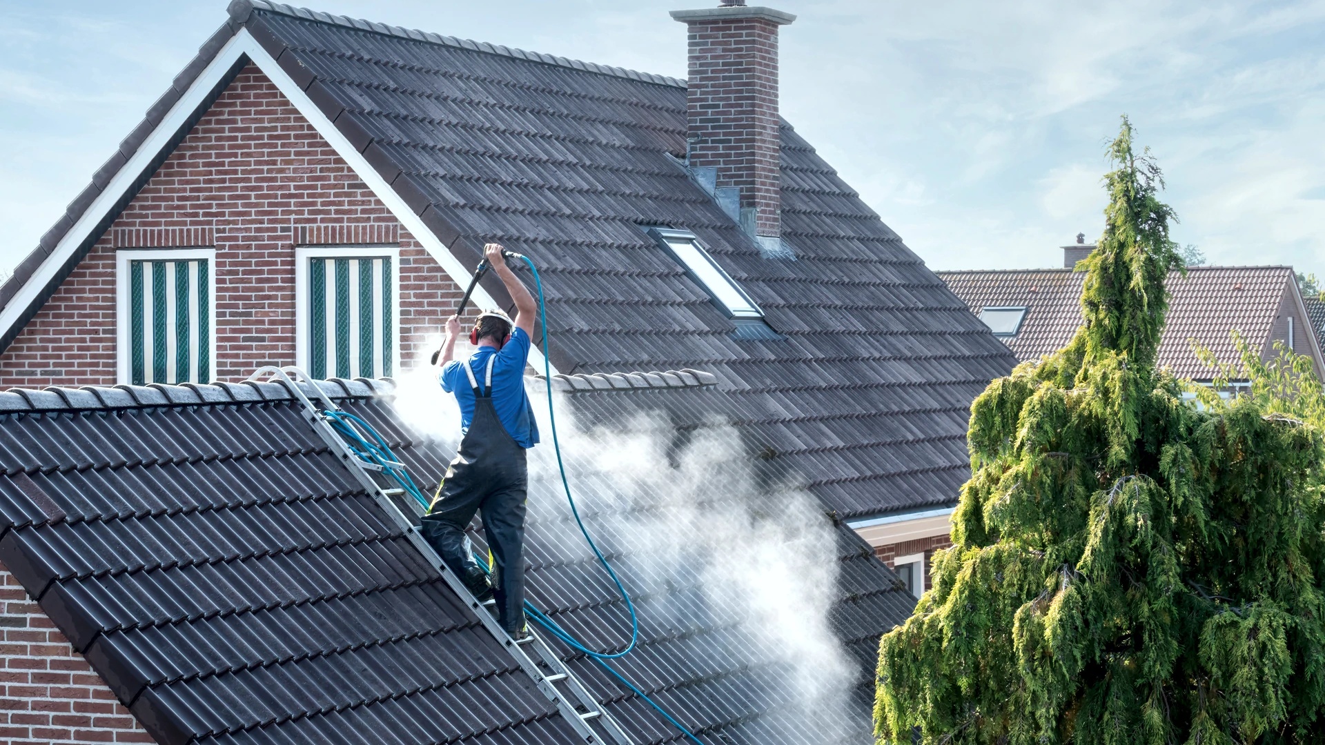 Professional roof cleaning work on UK residential property